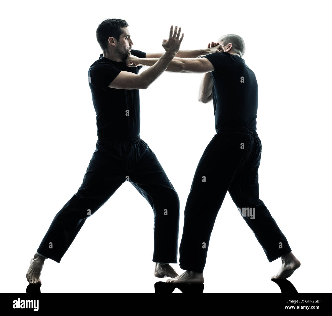 two caucasian men krav maga fighters fighting isolated silhouette on