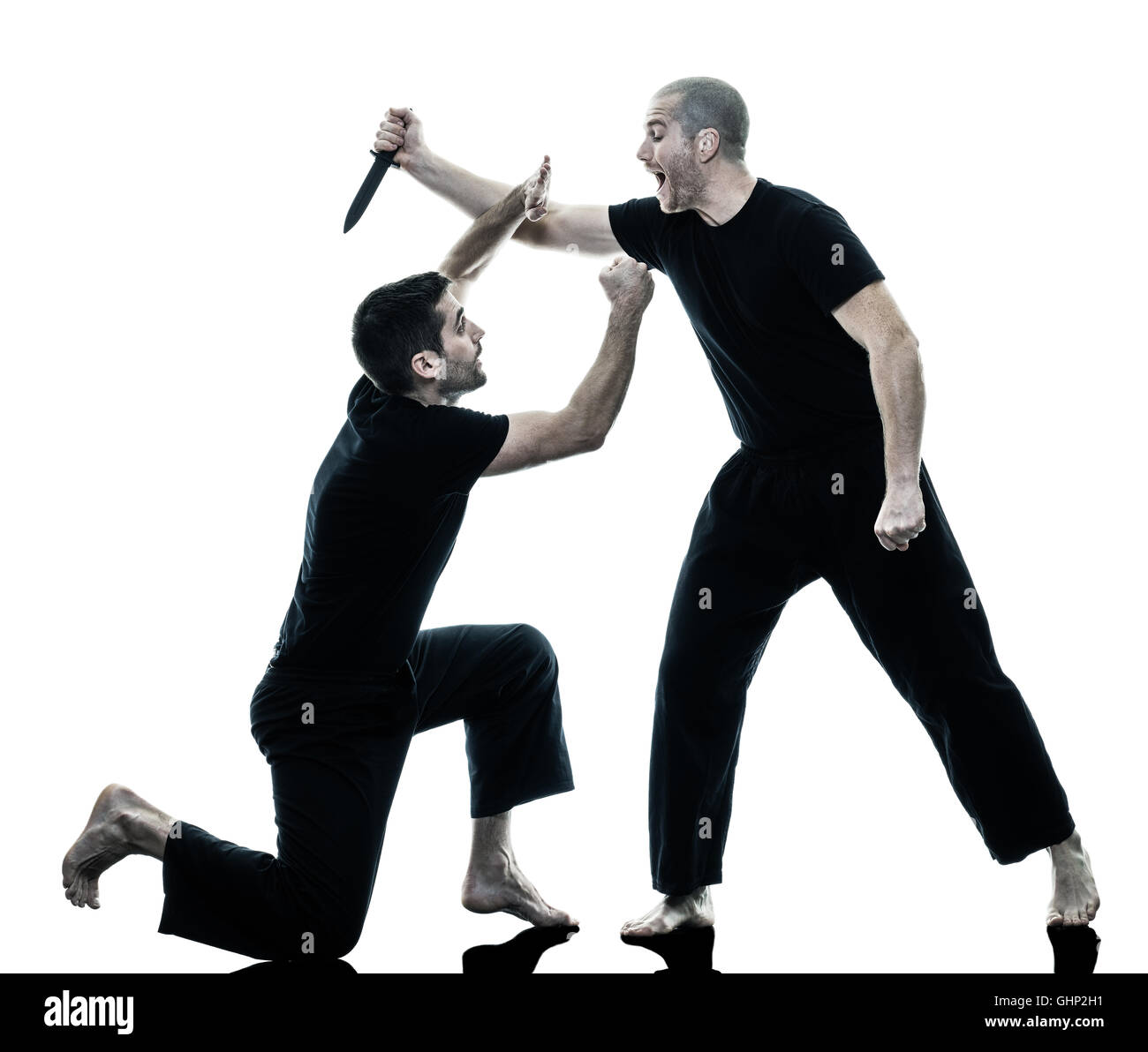 two caucasian men krav maga fighters fighting isolated silhouette on white  background Stock Photo - Alamy