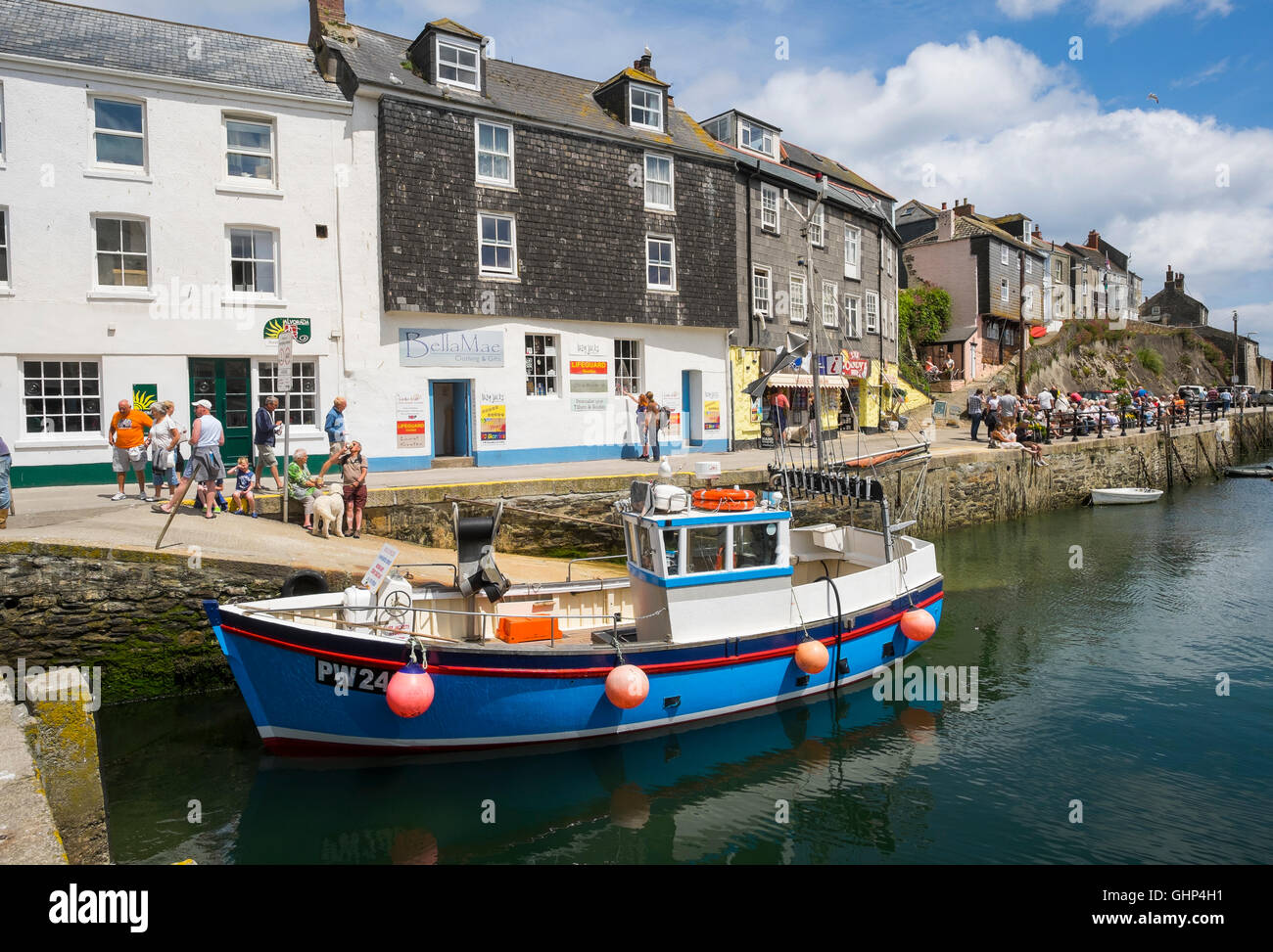 A blue and white fishing boat moored in Mevagissey harbour, Cornwall, England, UK Stock Photo