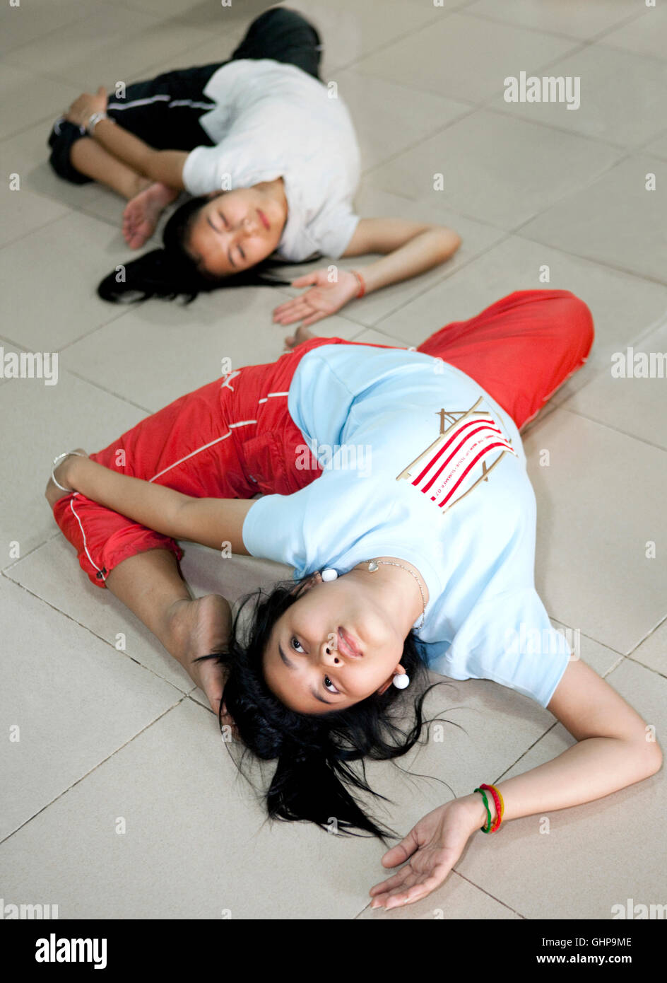 Students from Cambodia Living Arts stretch before a class. Phnom Penh, Cambodia Stock Photo