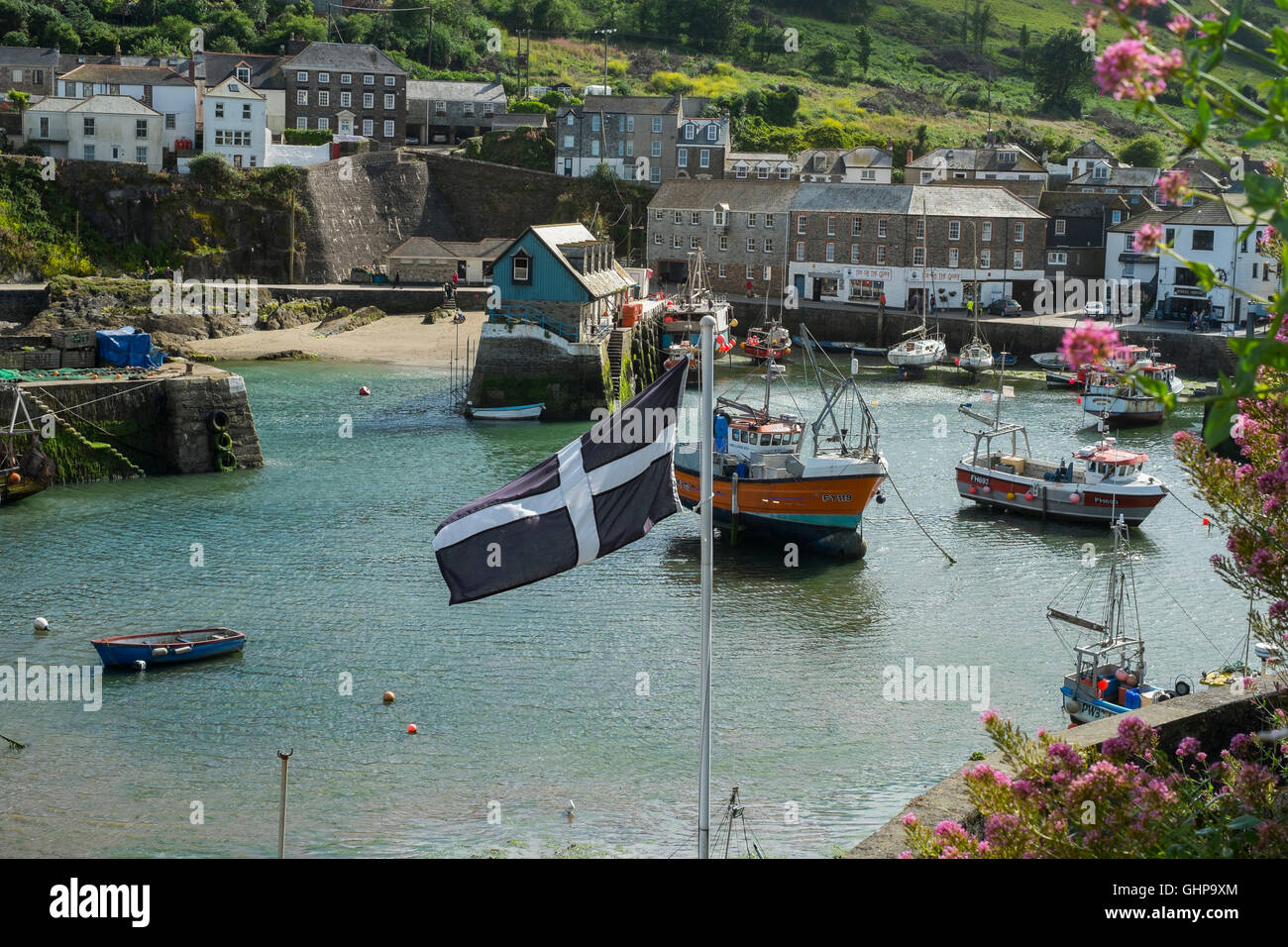 Cornish flag flying over Mevagissey Harbour, Cornwall, England, UK Stock Photo