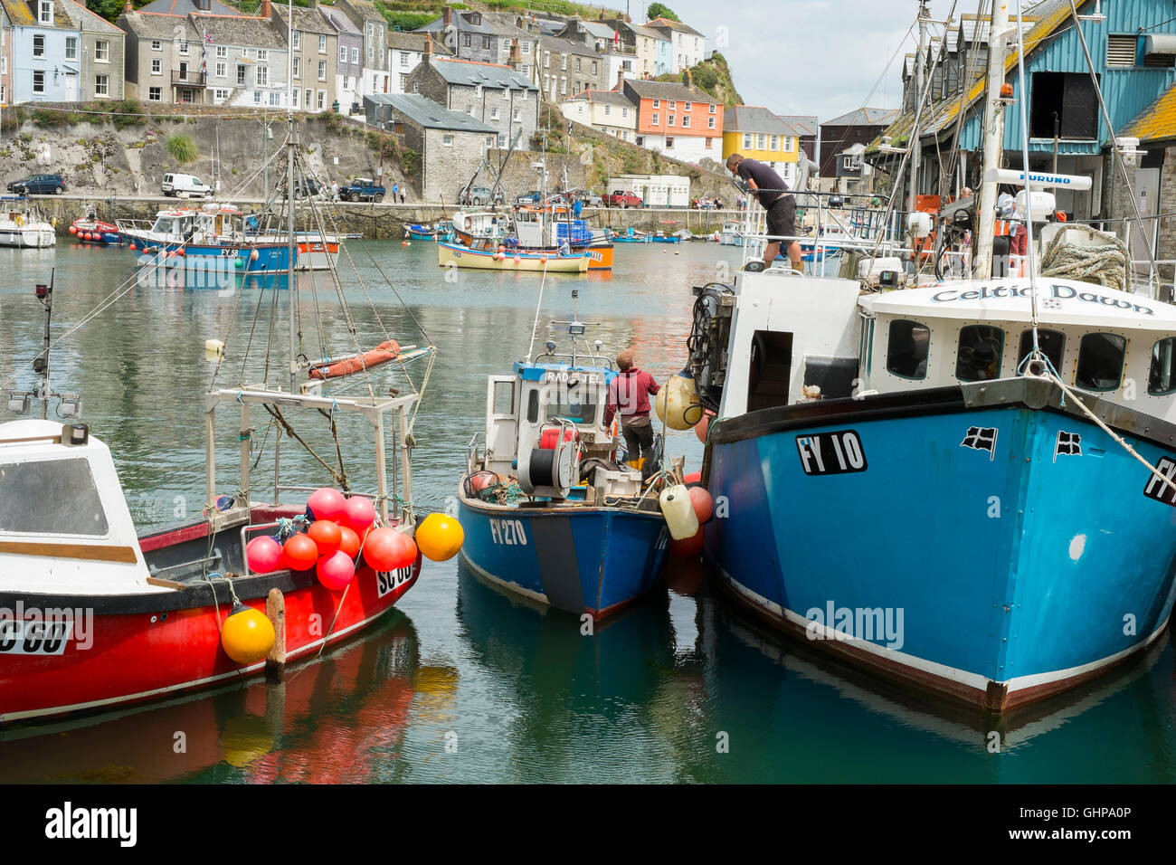Fisherman and boats in Mevagissey Harbour, Cornwall, England, UK Stock Photo