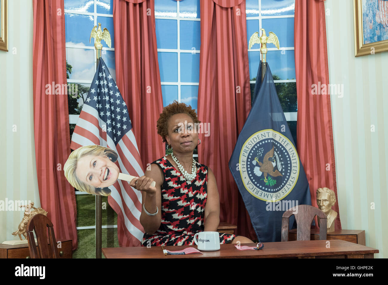 An attendee at the Democratic National Convention poses in the Instagram mini Oval Office sponsored by Facebook at the Wells Fargo Center July 27, 2016 in Philadelphia, Pennsylvania. Stock Photo