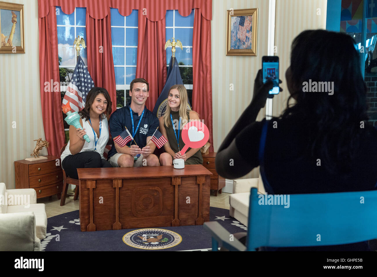 Attendees at the Democratic National Convention poses in the Instagram mini Oval Office sponsored by Facebook at the Wells Fargo Center July 27, 2016 in Philadelphia, Pennsylvania. Stock Photo