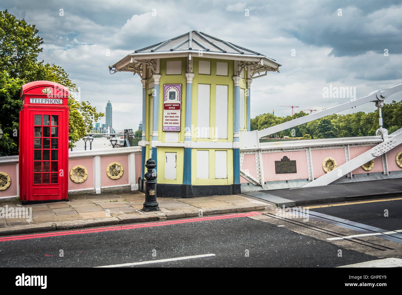 A red London telephone kiosk and tollbooth on Albert Bridge, Chelsea, London, England, UK Stock Photo