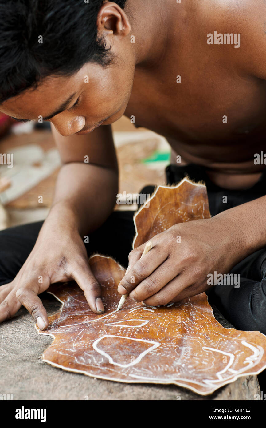 Artists from Cambodia Living Arts make shadow puppets at their home in Siem Reap, Cambodia. Stock Photo