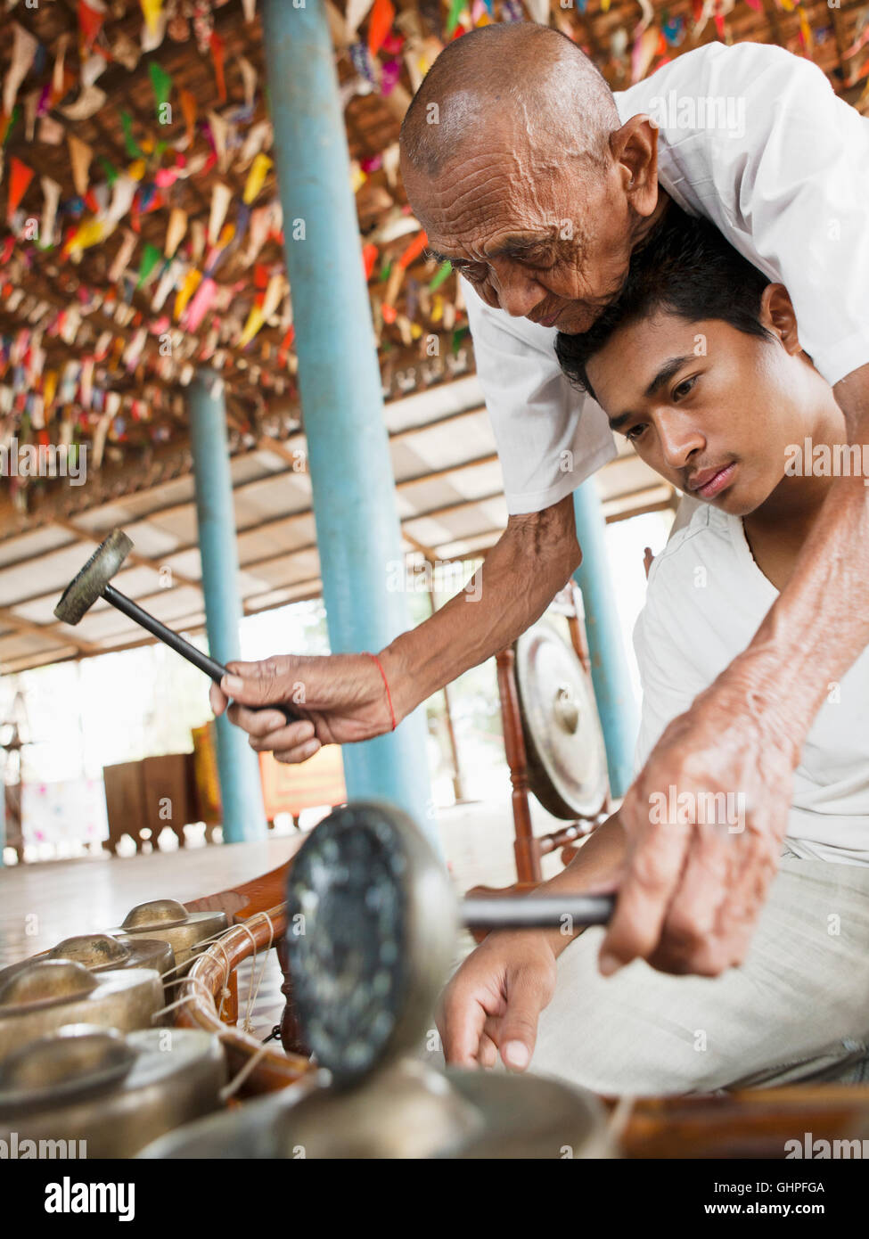 Kantoam Ming (Kan toeming ) Master Ling Srei. ( Srey) teaches a student the Kong vong. Seim Reap,Cambodia Stock Photo