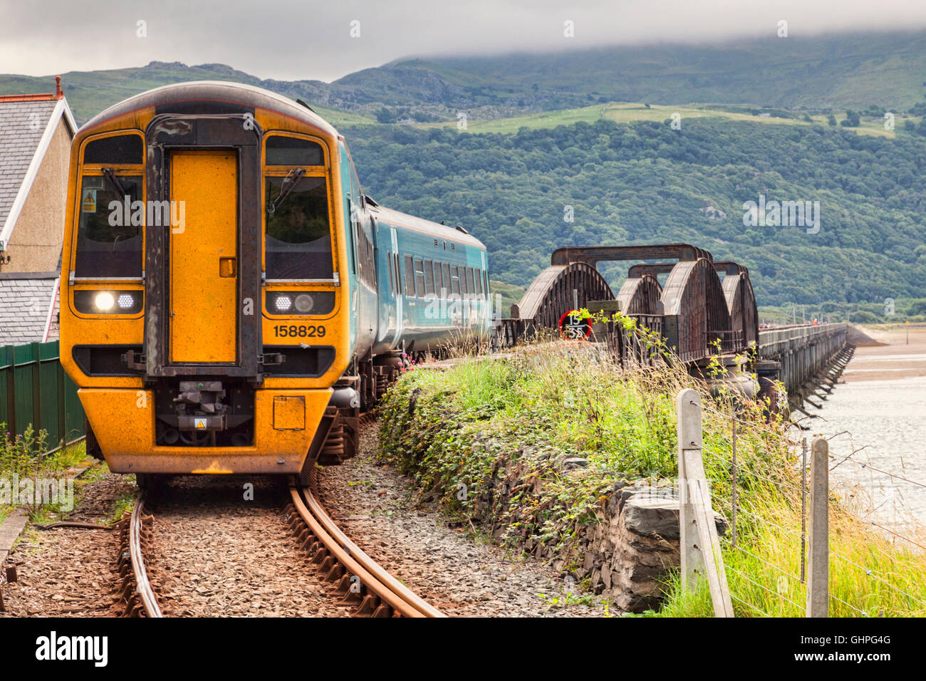 Diesel Multiple Unit of the Cambrian Coastal Railway, having just crossed the Barmouth Viaduct, Gwynedd, Wales, UK Stock Photo