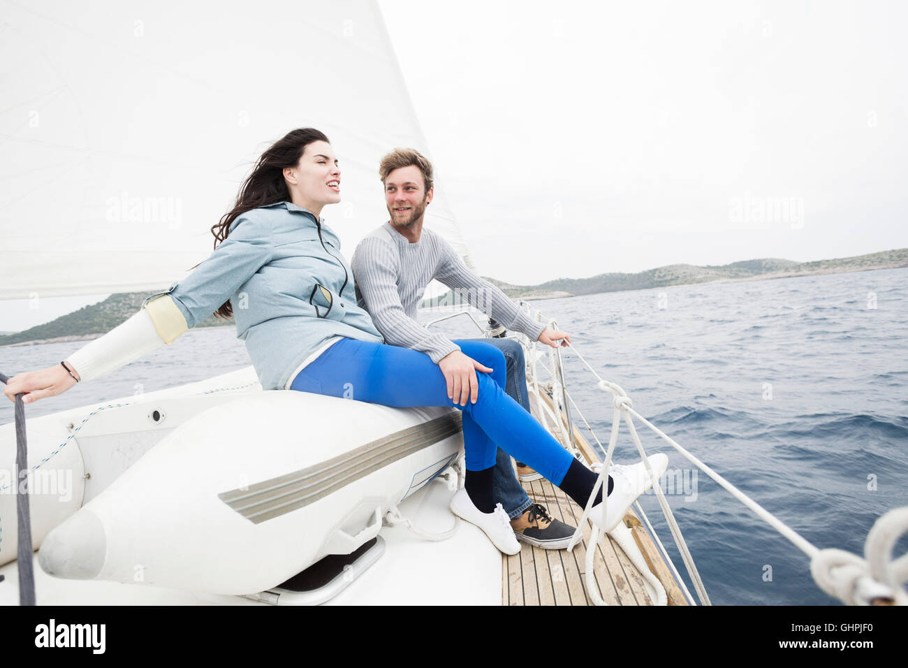 Young couple on yacht looking out to sea Stock Photo