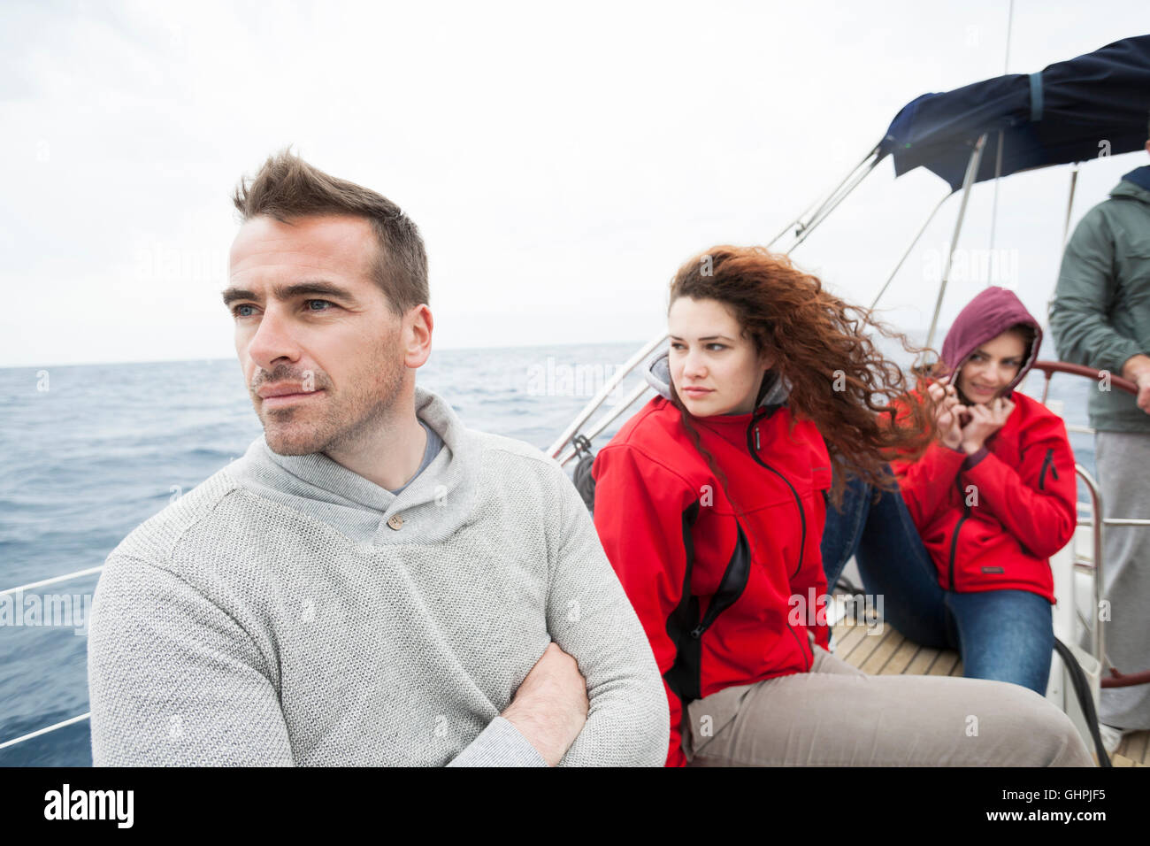 Group of friends on yacht looking out to sea Stock Photo