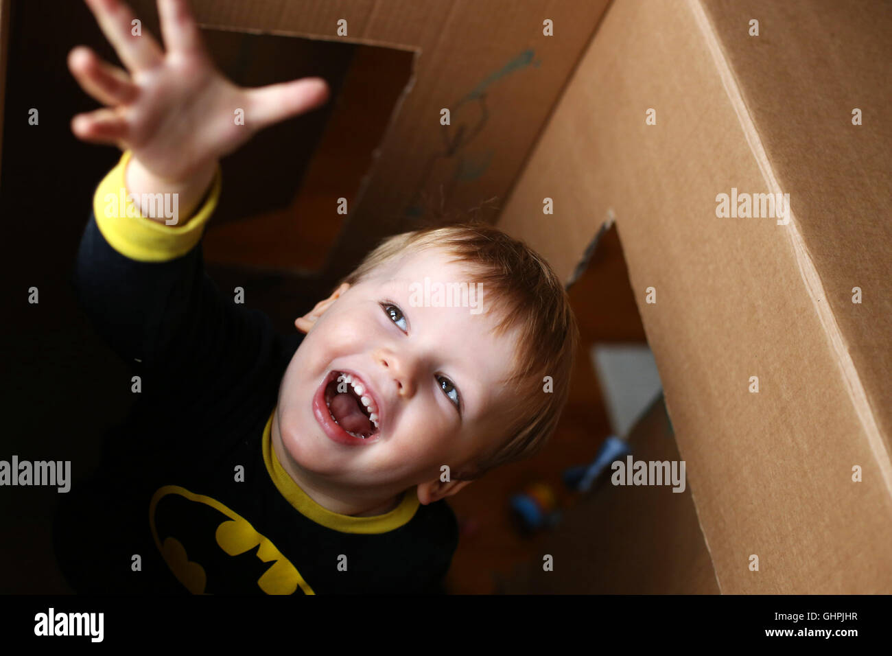 Boy reaching cardboard box hi-res stock photography and images - Alamy