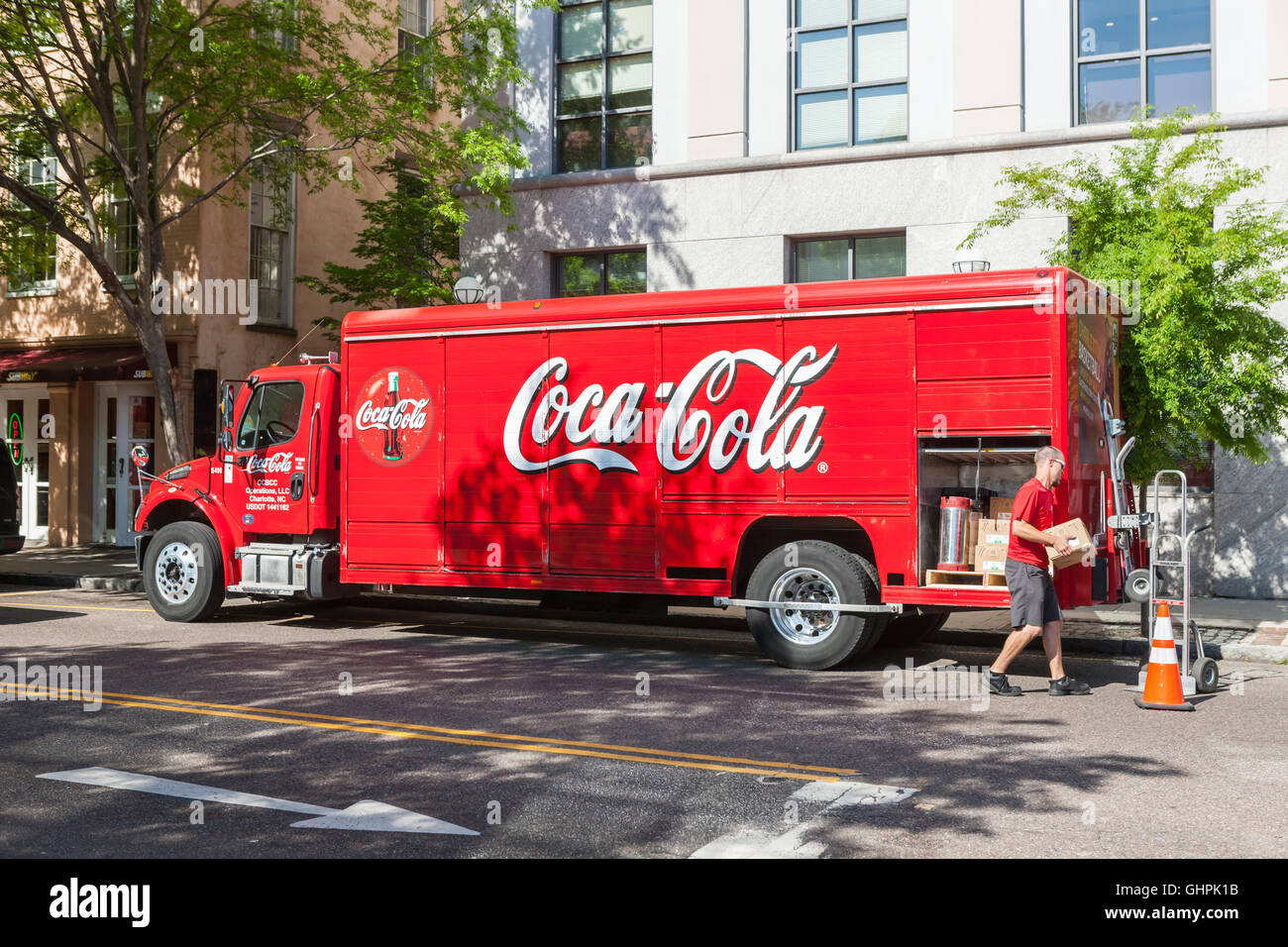 A delivery man unloads a Coca-Cola beverage truck on Meeting Street in Charleston, South Carolina. Stock Photo