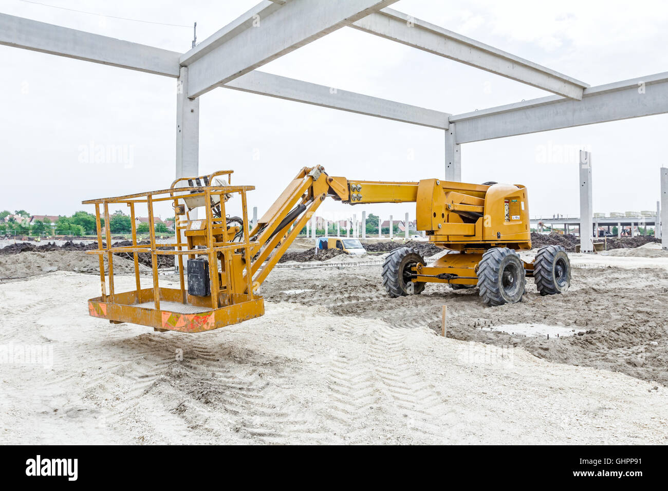 Cherry picker is parked below concrete skeleton of new assembled ...