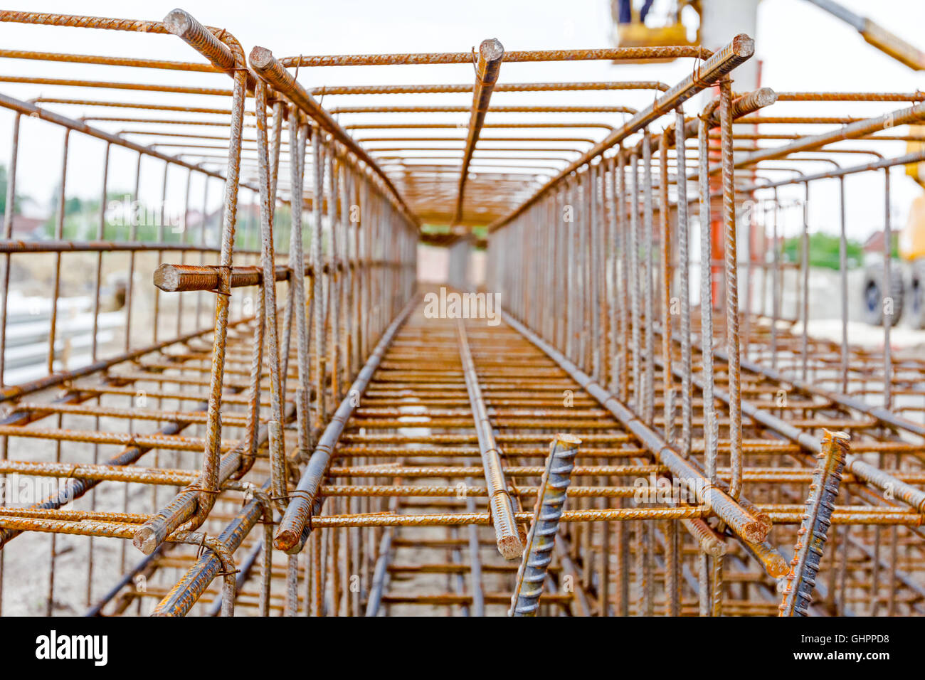 View perspective trough cage, skeleton of reinforcing steel bar at construction site. Stock Photo