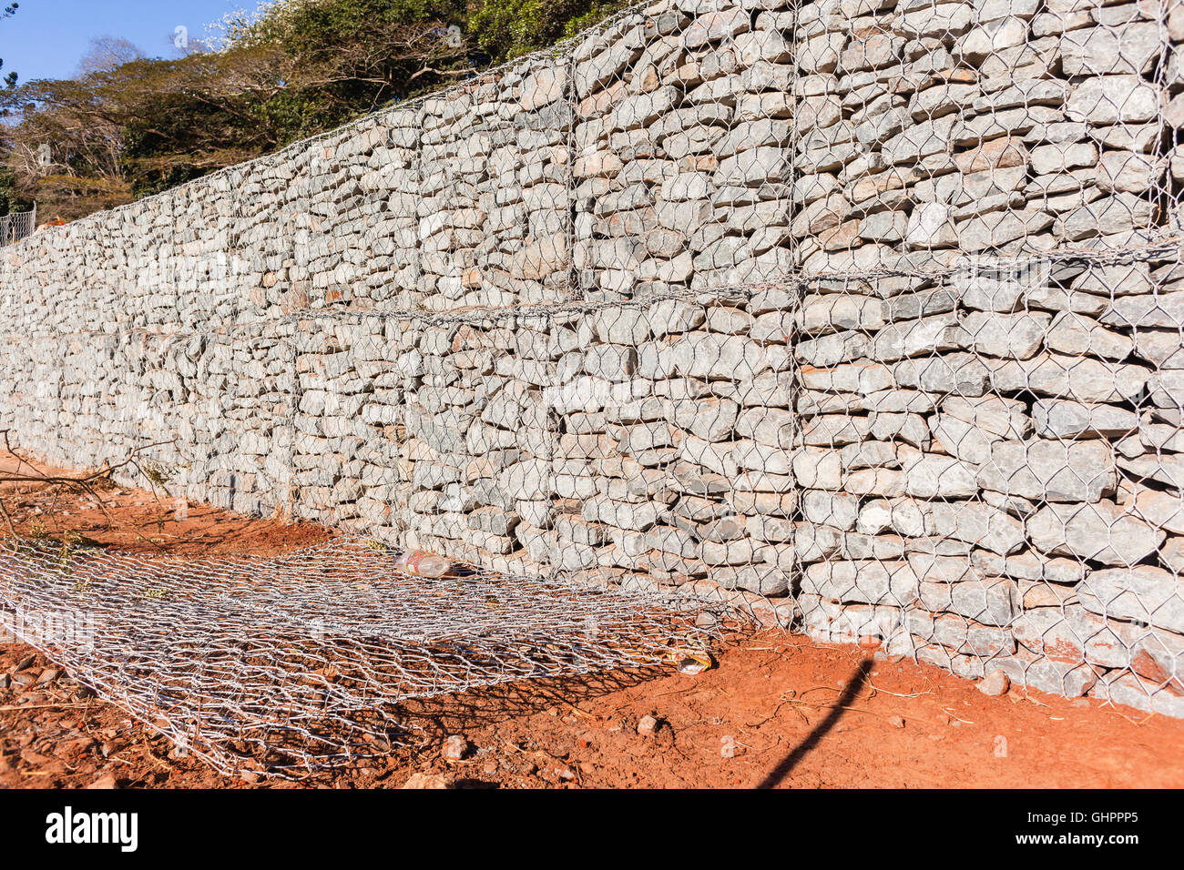 Stone wire constructed retainer wall closeup on building construction ...