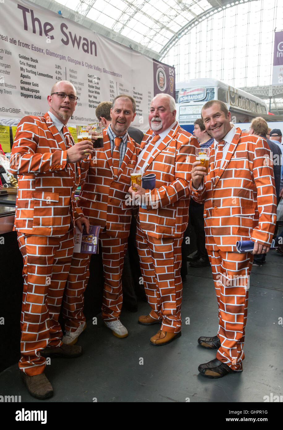 4 men drinking beer wearing  matching 'brick' style suits at the Great British Beer festival at Olympia,West London Stock Photo