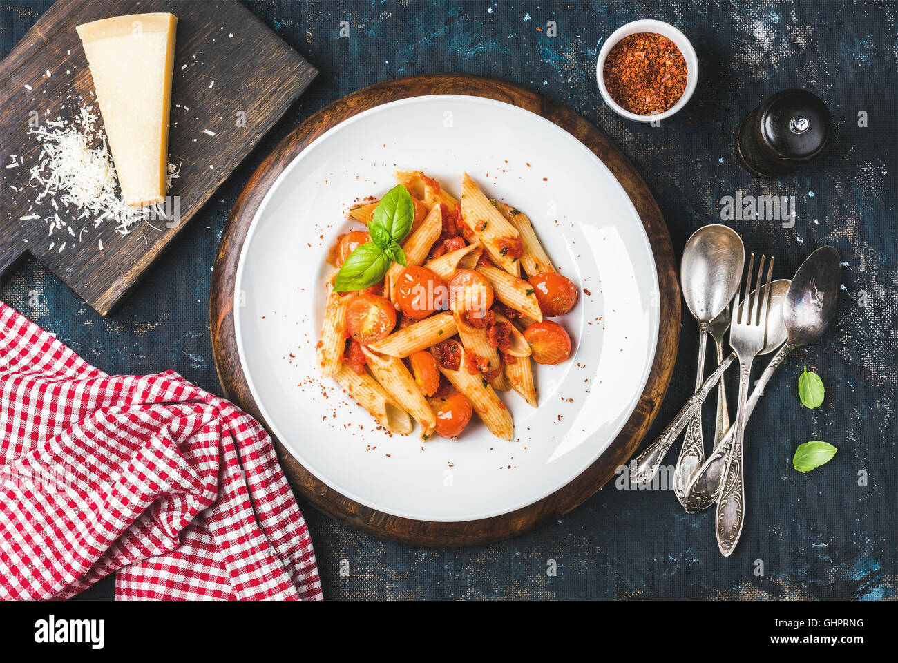 Pasta penne with tomato sauce, basil and roasted tomatoes Stock Photo
