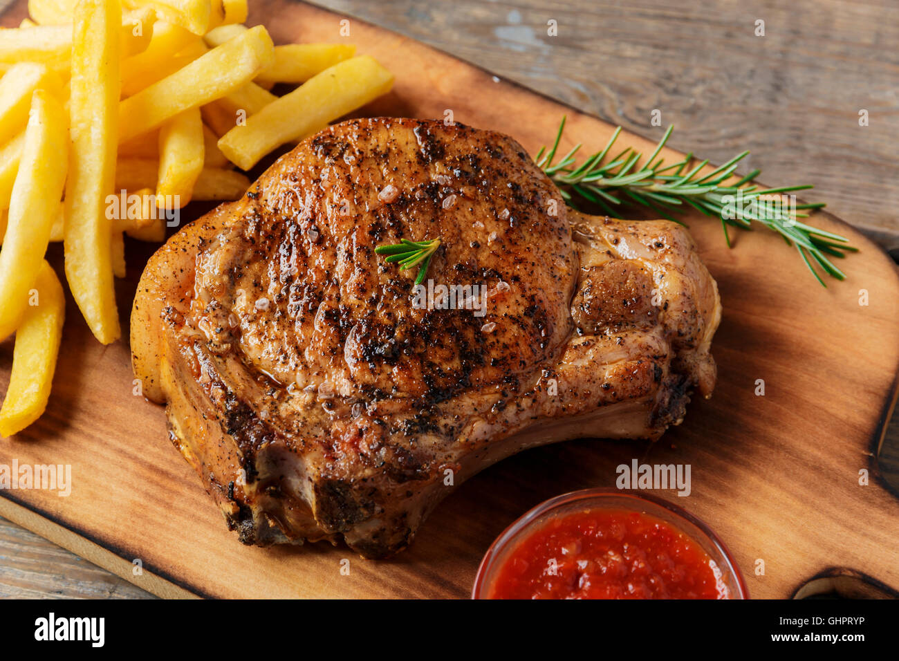 steak on the bone steak with french fries and sauce Stock Photo