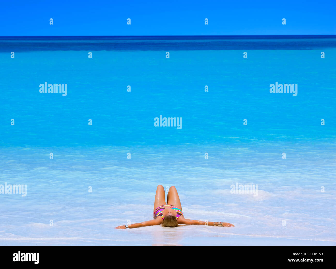 Woman sunbathing at Anse Volbert in Praslin, Seychelles islands Stock Photo