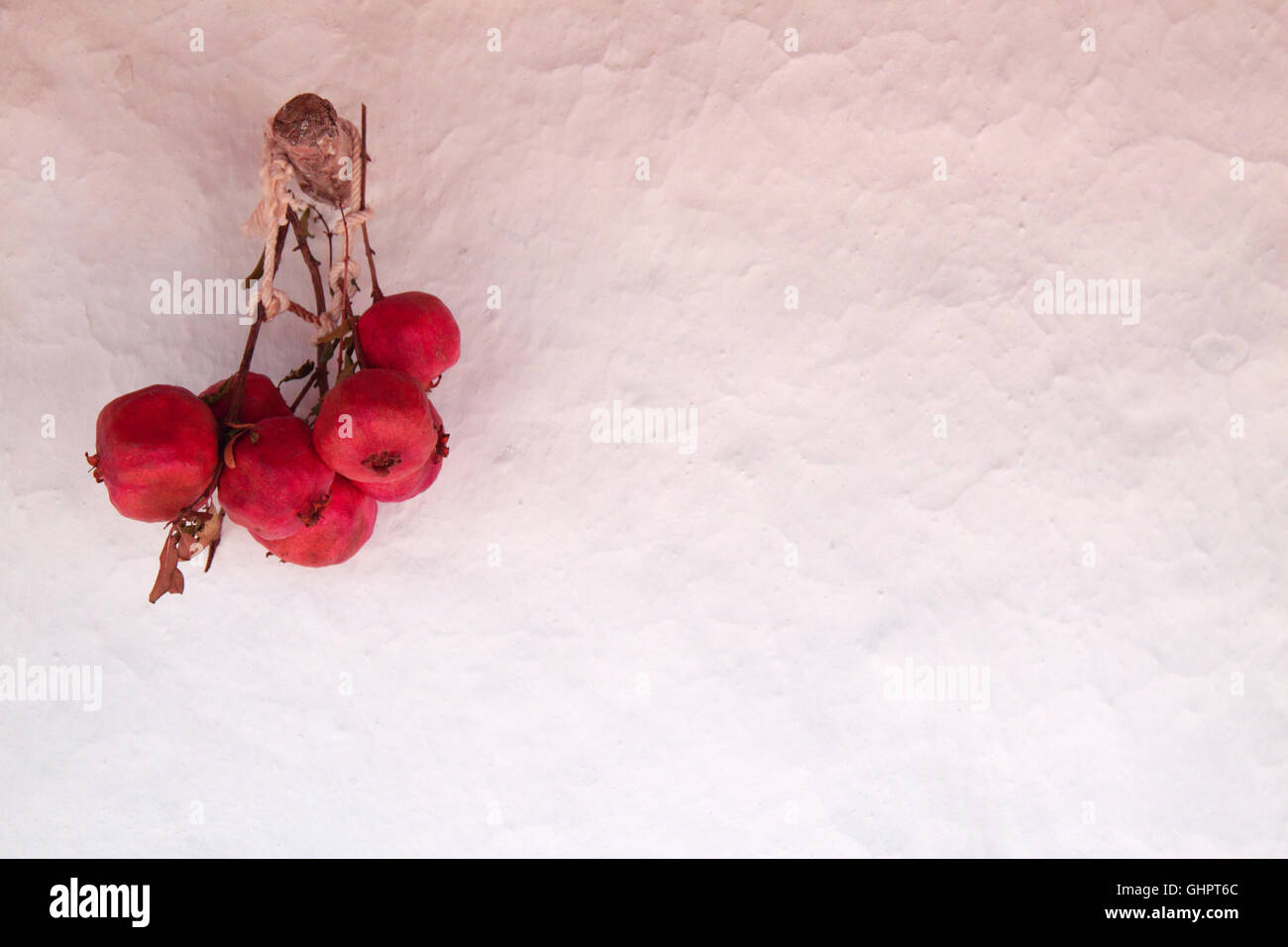 dried pomegranate hanging on the wall Stock Photo