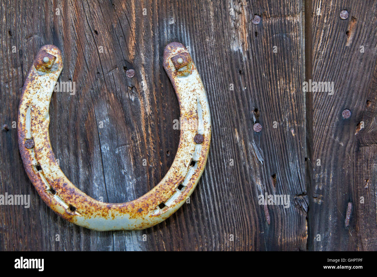 Old horse shoe on wooden background Stock Photo - Alamy
