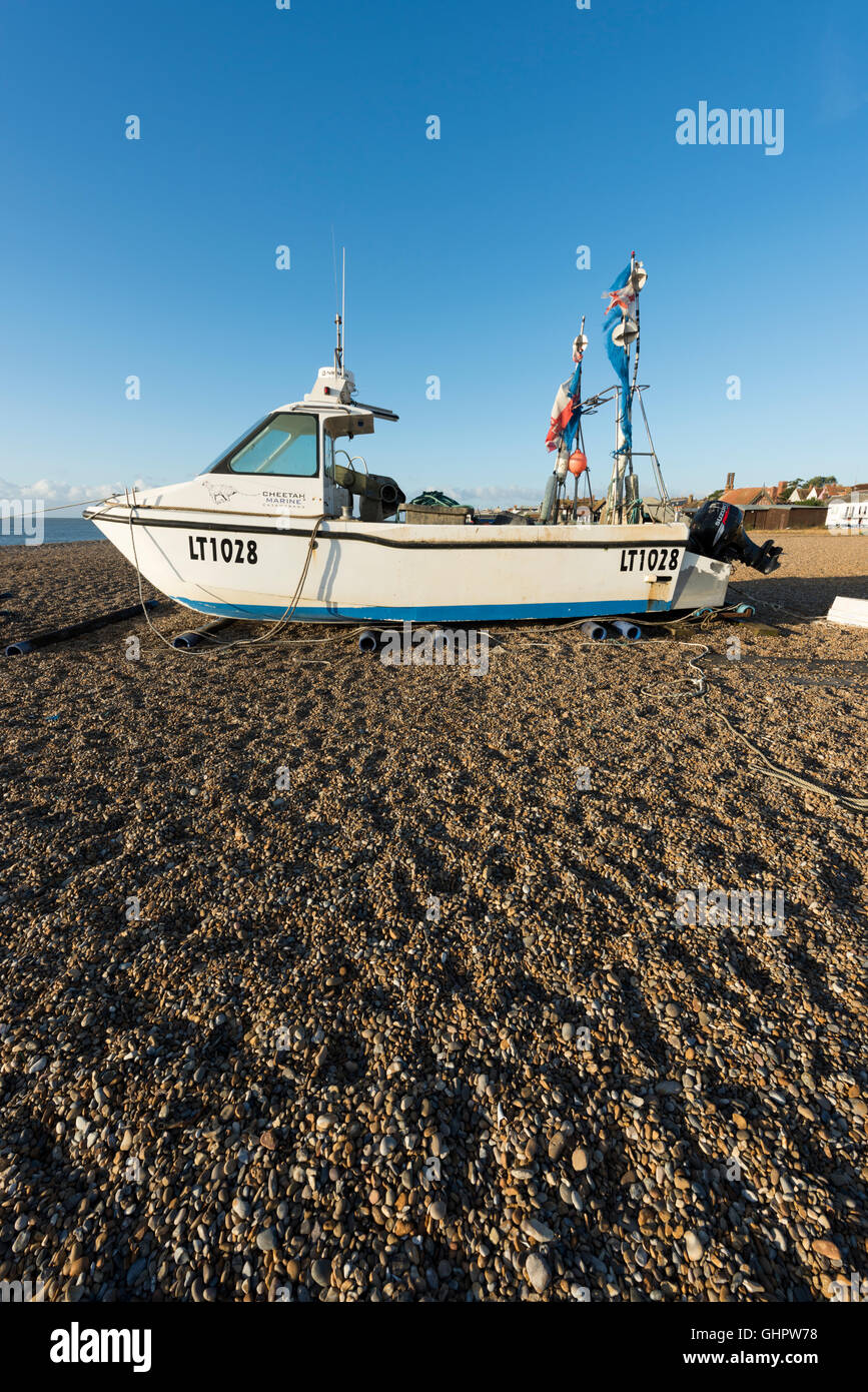 Commercial fishing boats, nets and equipment on the shingle beach at