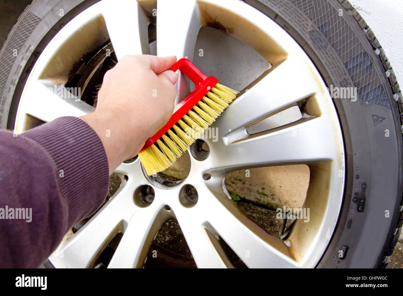 Man cleaning alloy wheels with a brush Stock Photo Alamy