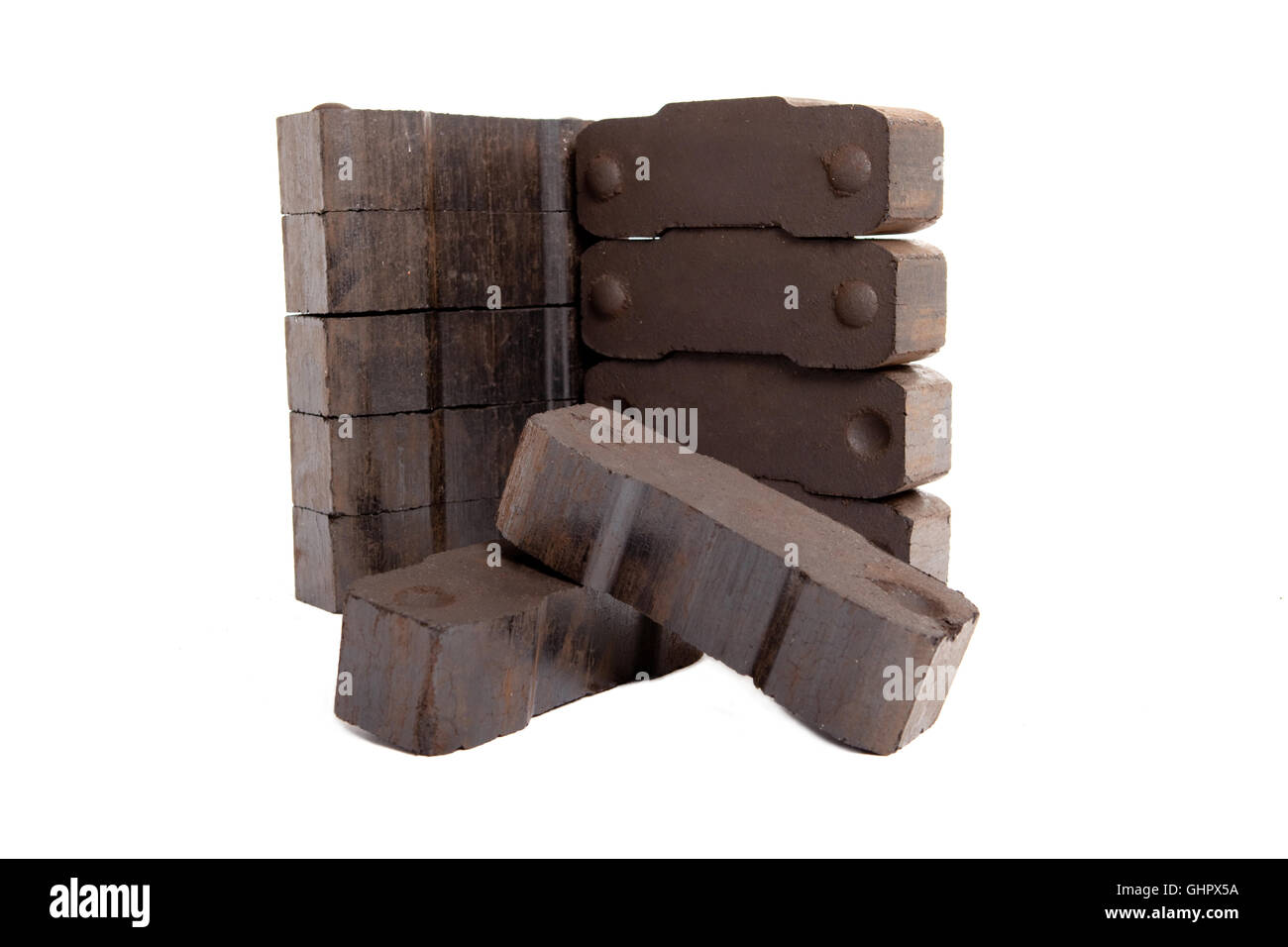 tower of lignite briquettes with two single bricks in front, white background, isolated, copy space, Stock Photo