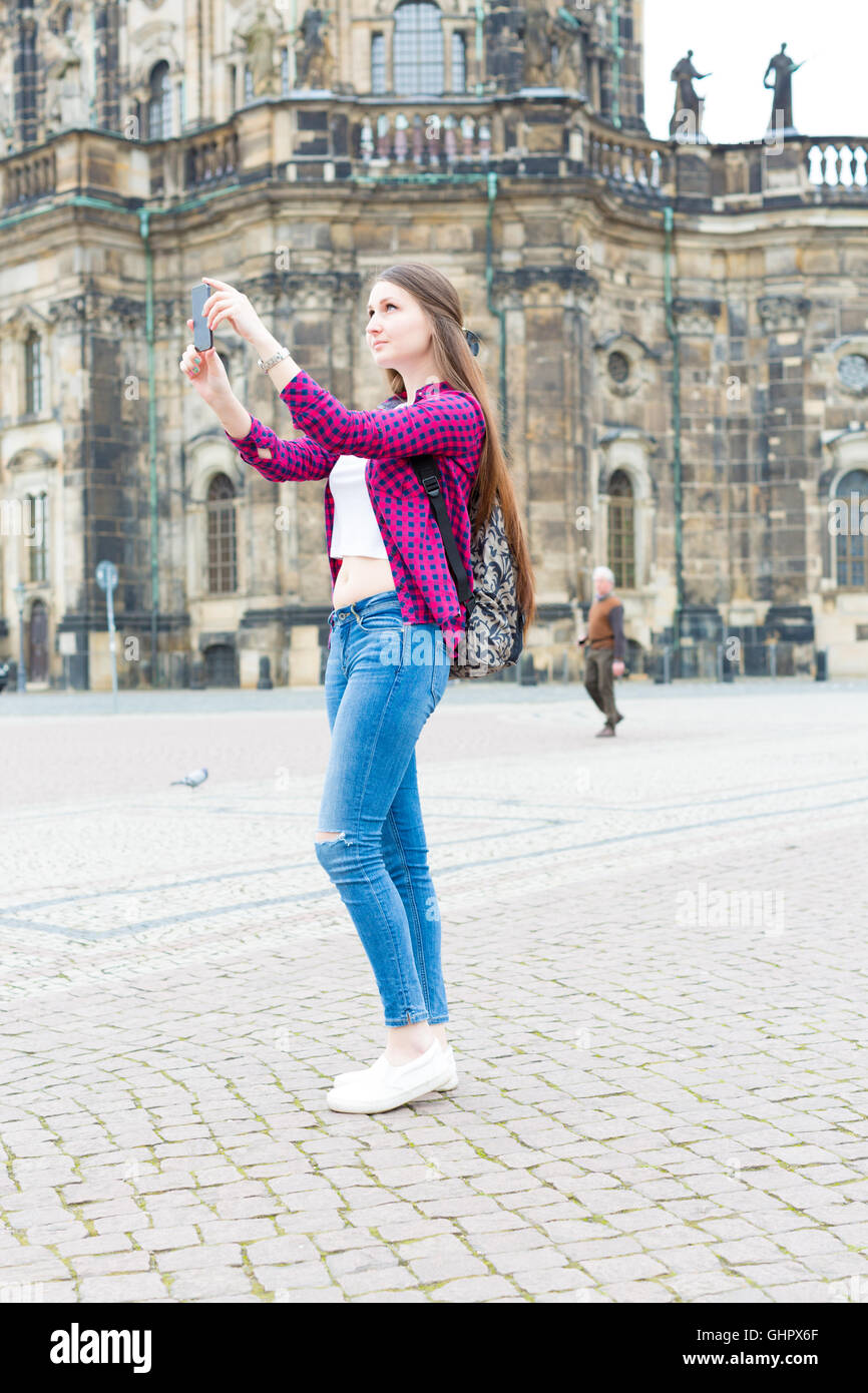 Woman tourist photographs the historic city center of Dresden, Germany Stock Photo