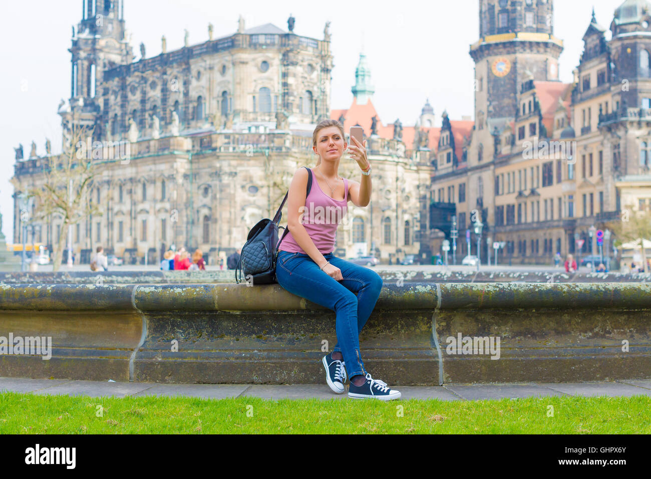 Woman tourist photographs the historic city center of Dresden, Germany Stock Photo