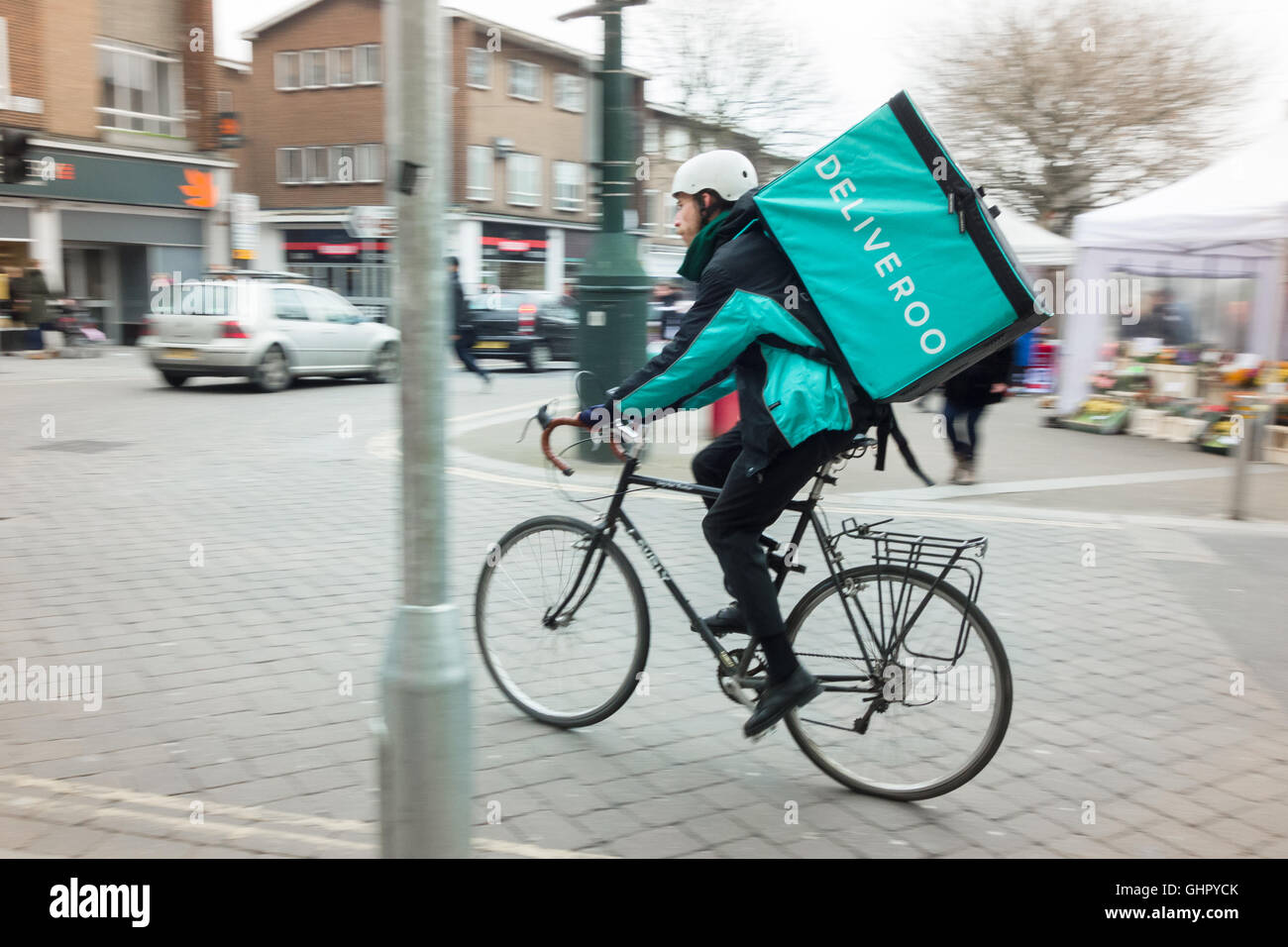 Deliveroo  - Deliveroo bicycle courier delivering restaurant food in Exeter, Devon, UK Stock Photo