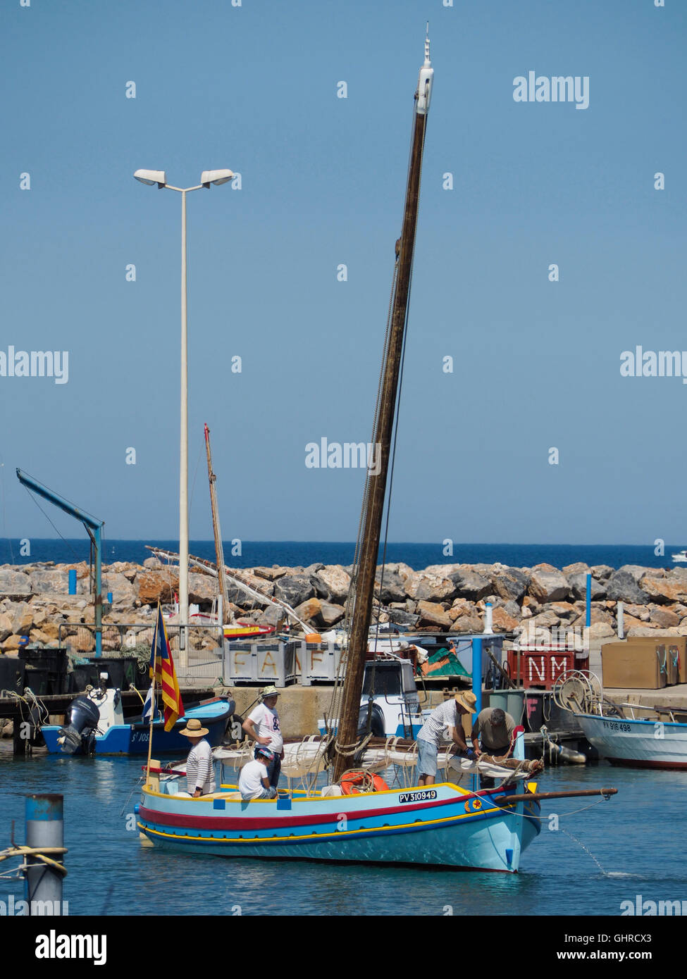 Colourful traditional fishing boat entering the port of Le Barcares, Pyrenees Orientales, Southern France Stock Photo