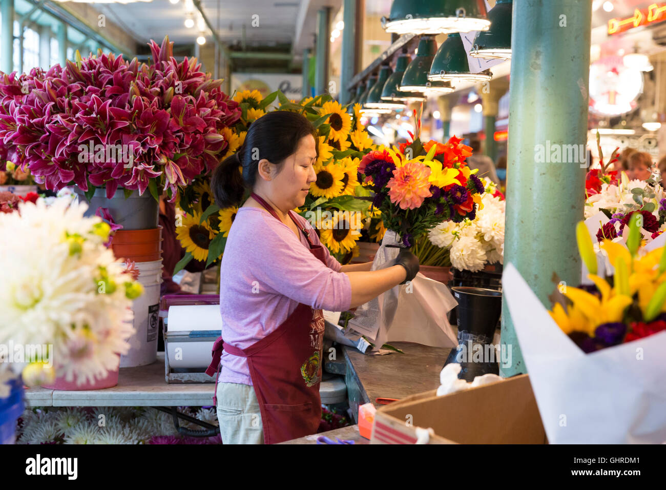 Seattle, Washington A merchant arranges bouquets of summer flowers at