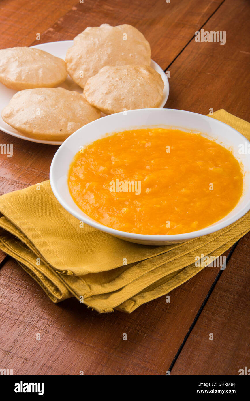 Aamras or Aam Ras Puri: Puri which is an indian fried small bread and alphonso mango pulp is a popular lunch in summer Stock Photo