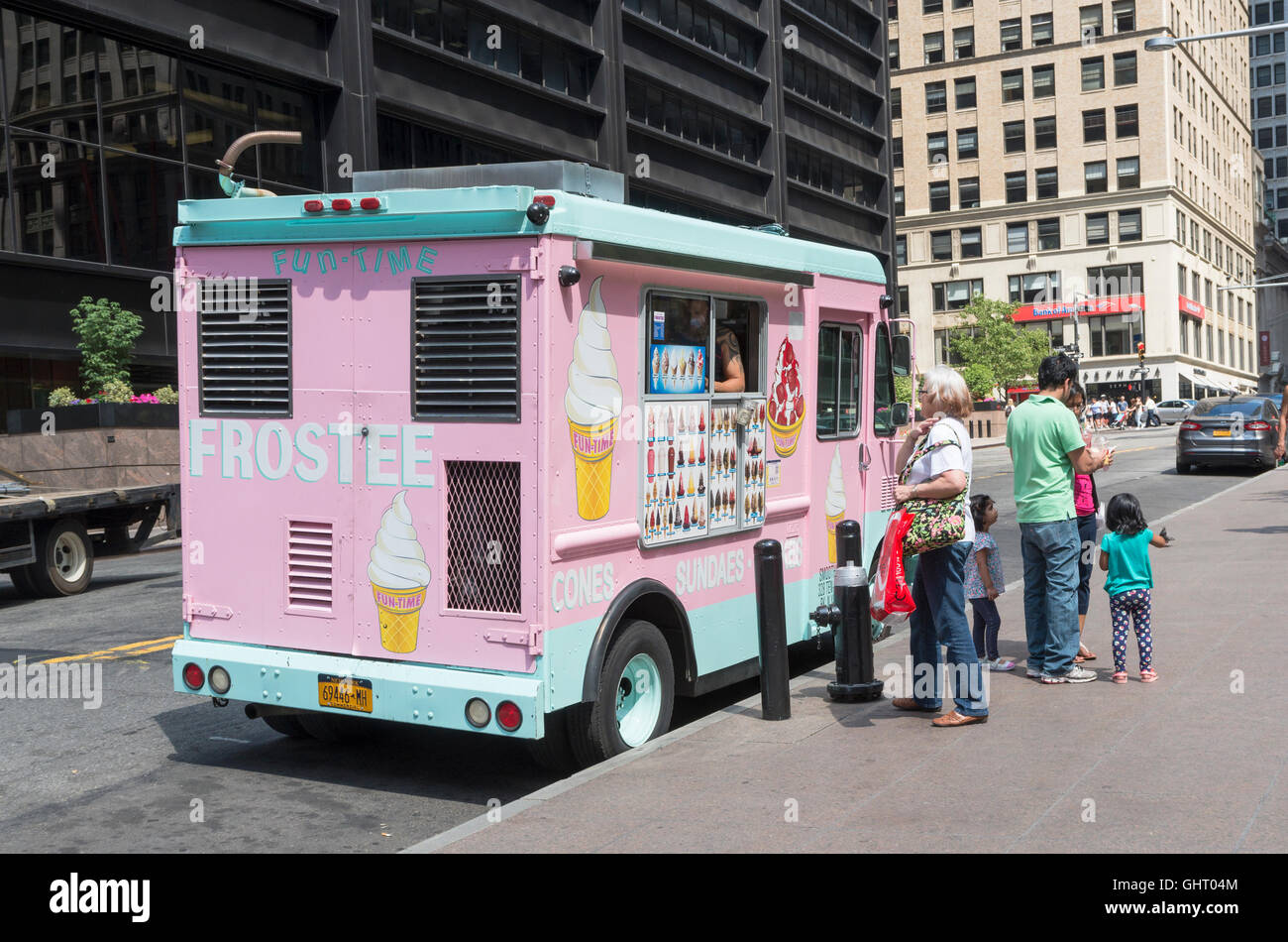 Woman and family buying ice creams from an ice cream van during a