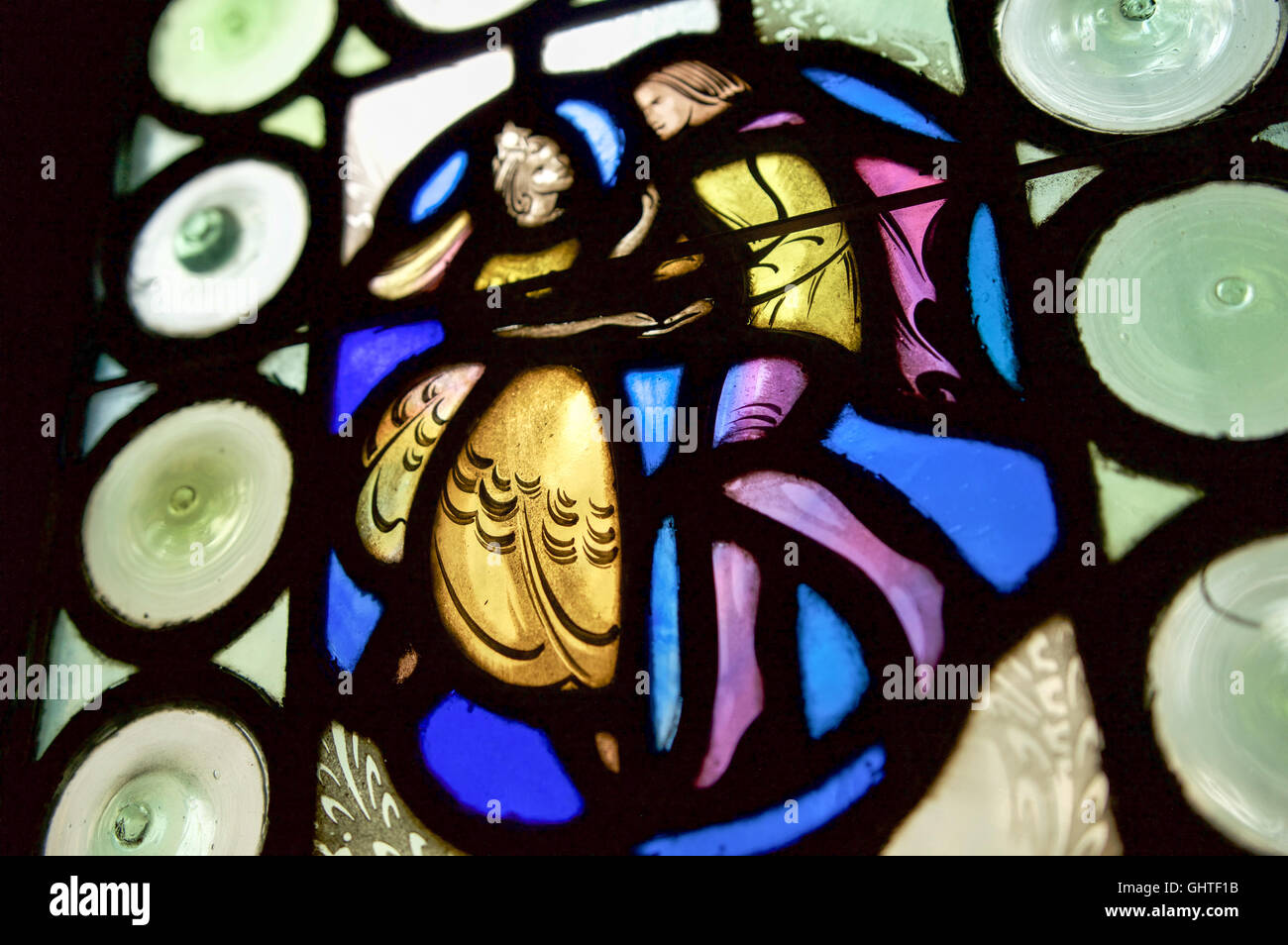 A colorful stained glass window illustrates a scene from a German folktale or fairy tale Stock