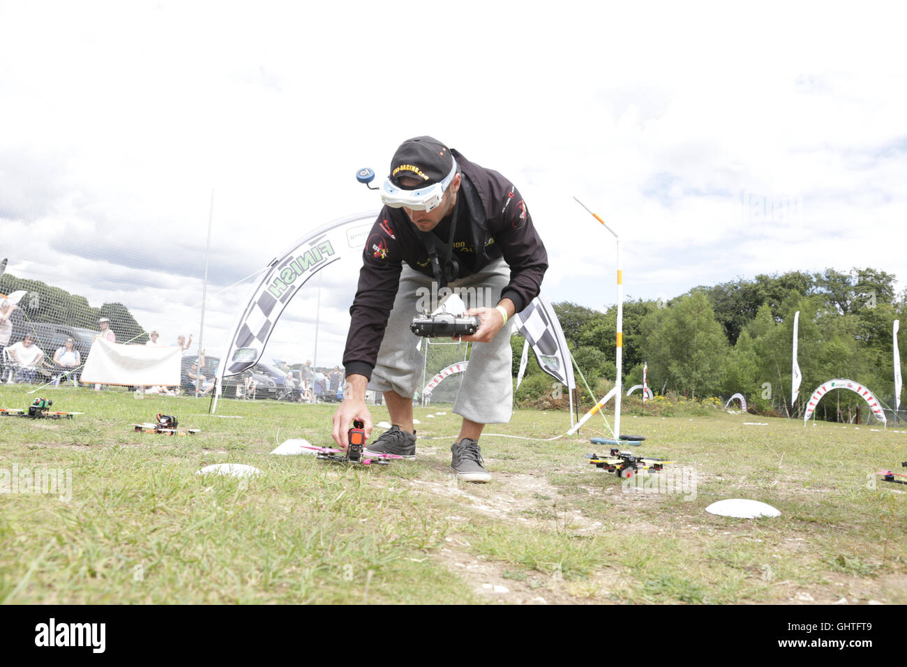 Drone Racing Queen's Cup 2016.  Gary Kent places a drone at thestart line prior to a race. prior to racing. Stock Photo