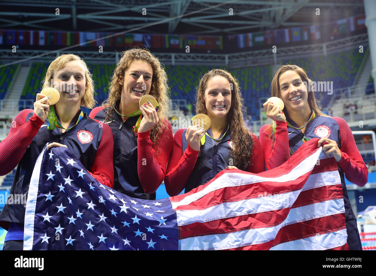 Rio de Janeiro, Brazil. 10th Aug, 2016. The swimming team of the USA displays their Gold medals after the Women's 4 x 200m Freestyle Relay Final of the Swimming events of the Rio 2016 Olympic Games at the Olympic Aquatics Stadium in Rio de Janeiro, Brazil, 10 August 2016. From left: Katie Ledecky, Allison Schmitt, Leah Smith, Madeline Dirado. Photo: Michael Kappeler/dpa/Alamy Live News Stock Photo