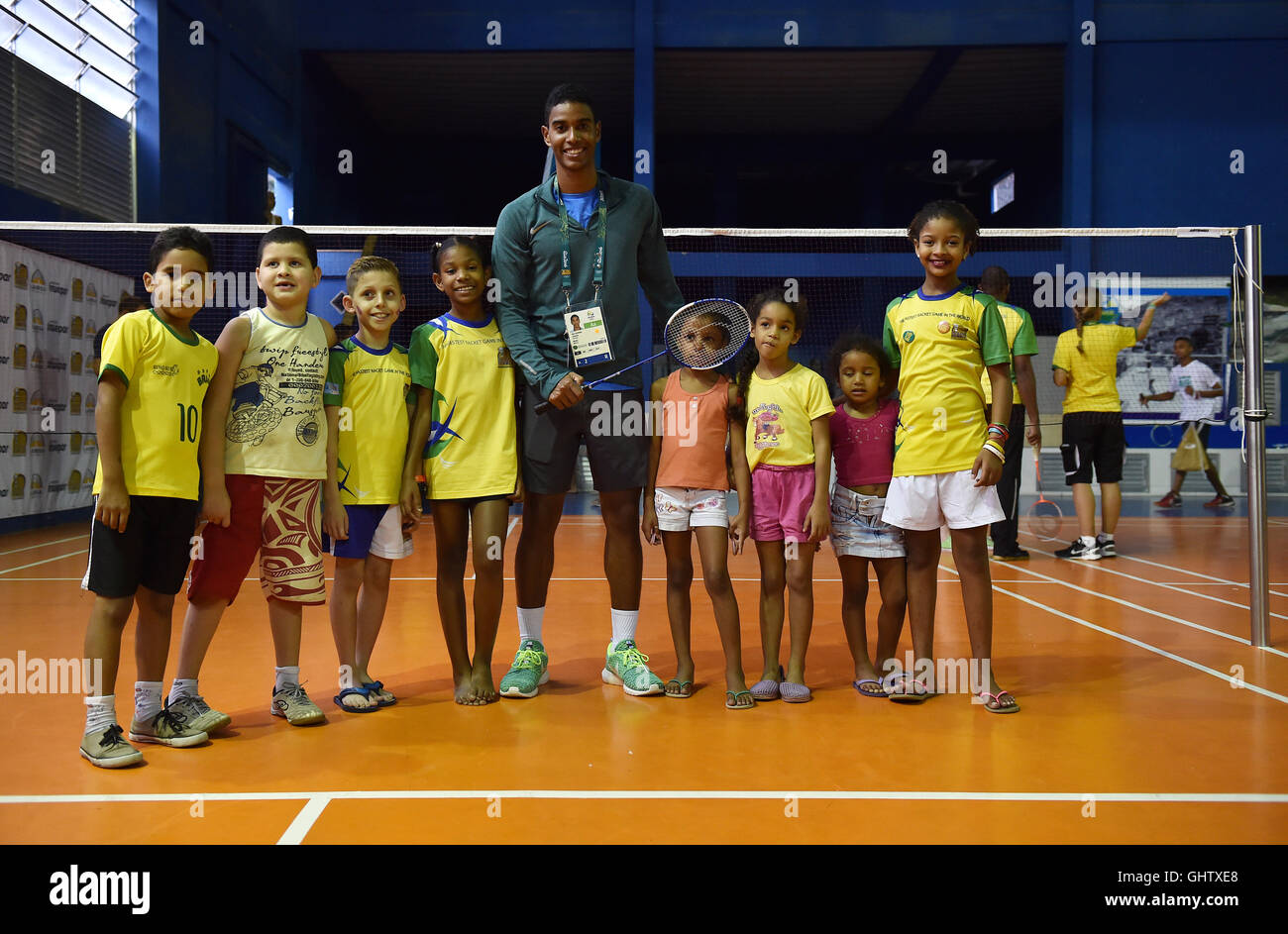 Rio de Janeiro, Brazil. 9th Aug, 2016. Brazilian badminton player Ygor  Coelho de Oliveira (c) is surrounded by children from the Miratus Centre in  the Chacrinha favela, which was founded by his