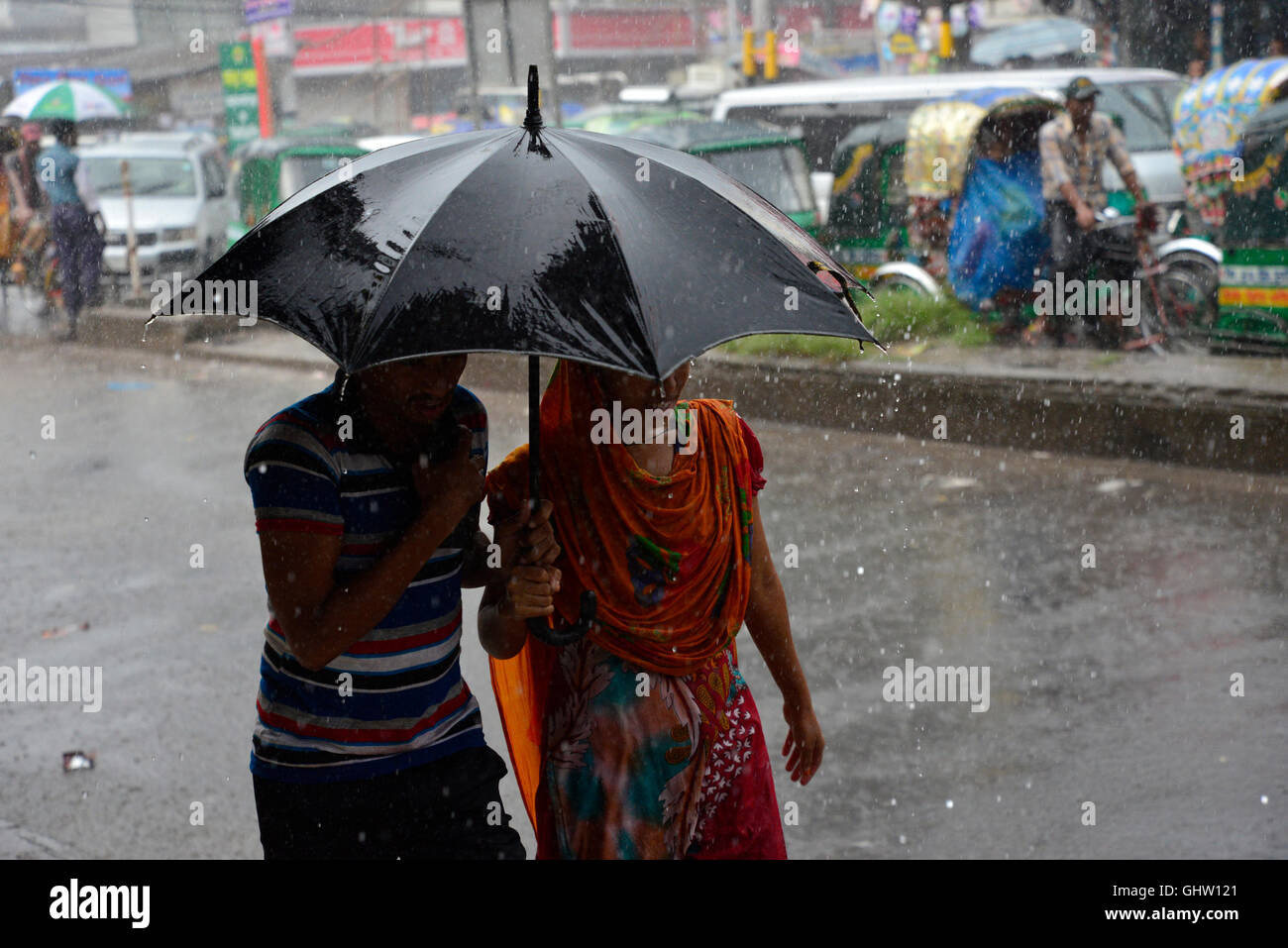 Dhaka, Bangladesh. 11th August, 2016. Bangladeshi women walks with
