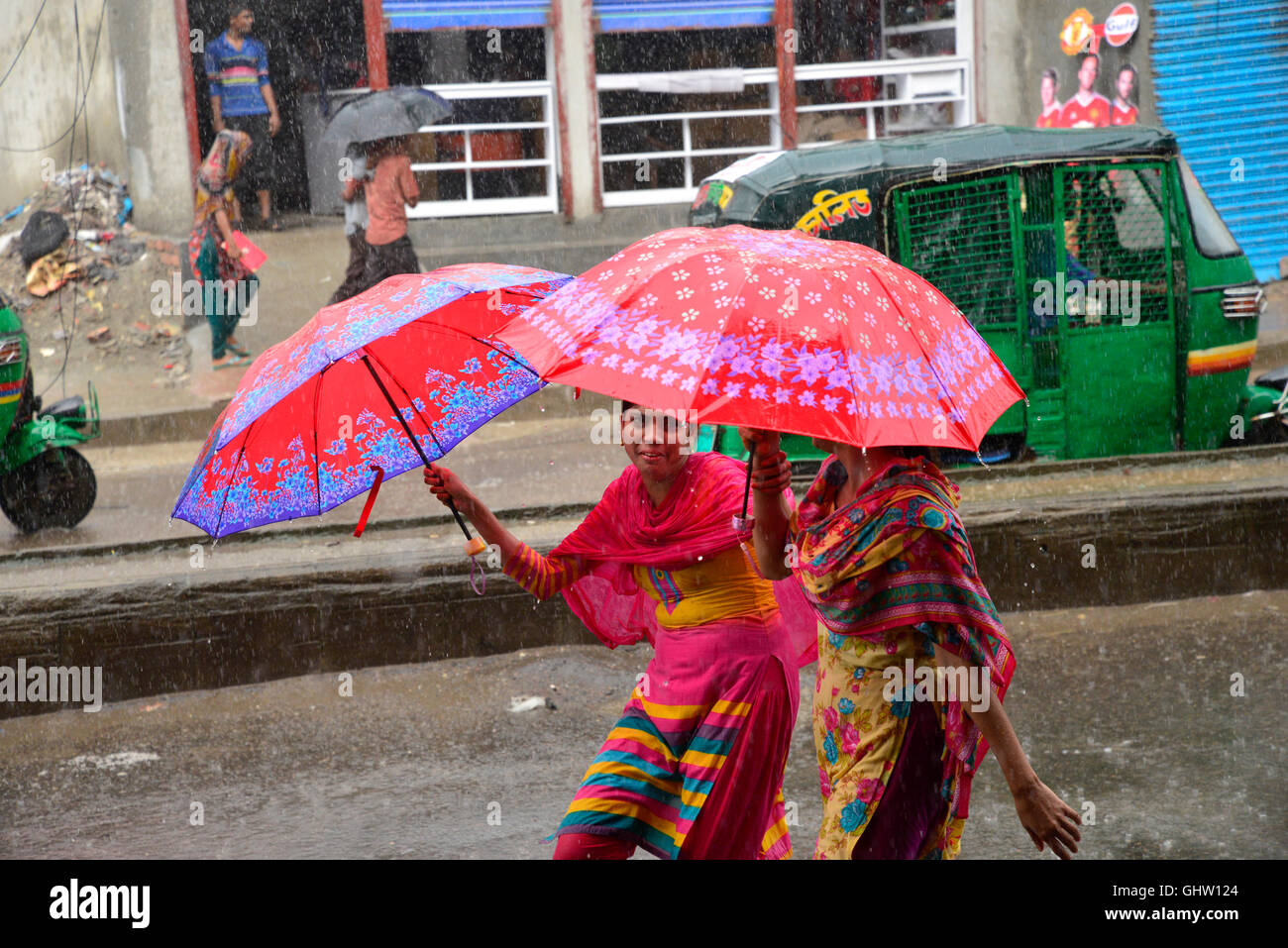 Dhaka, Bangladesh. 11th August, 2016. Bangladeshi women walks with