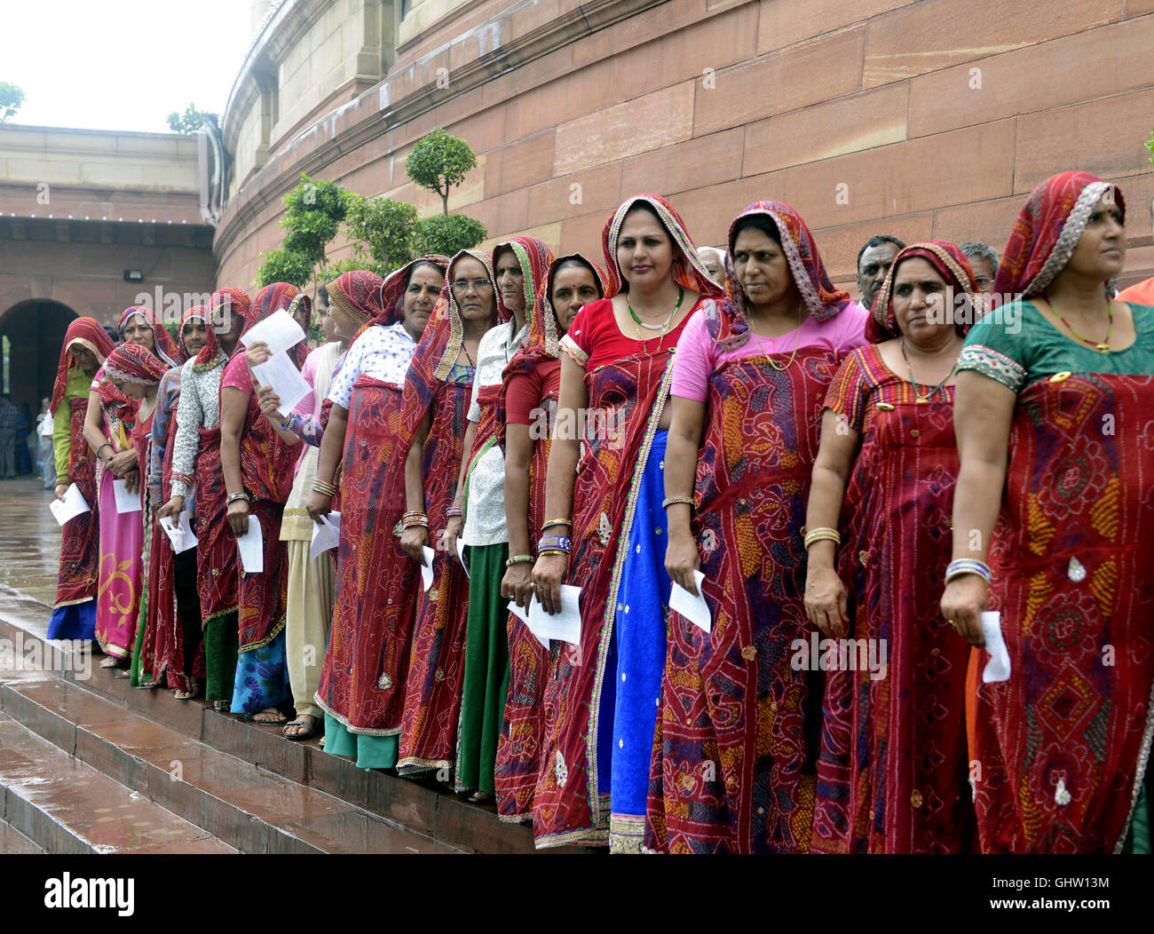 New Delhi, India. 11th Aug, 2016. Women dressed with traditional attire from Jhunjhunu district of Rajasthan wait in line to spectate the monsoon session in Indian parliament house in New Delhi, India, on Aug. 11, 2016. Credit:  Stringer/Xinhua/Alamy Live News Stock Photo
