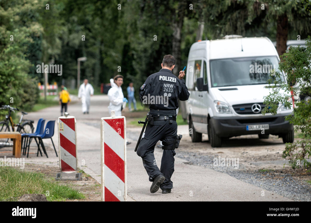 Dinslaken, Germany. 10th Aug, 2016. FILE - Policemen searching the refugee home at Fliehburg in Dinslaken, Germany, 10 August 2016. Due to the suspicion of preparing an explosive attack, the public prosecution of Duisburg arrested three residents of the refugee home in Dinslaken so far. A warrant of arrest is said to be ordered for the three men, senior public prosecutor Nowotsch told Deutsche Presse-Agentur on Thursday. PHOTO: ARNULF STOFFEL/dpa - NO WIRE SERVICE - © dpa/Alamy Live News Stock Photo