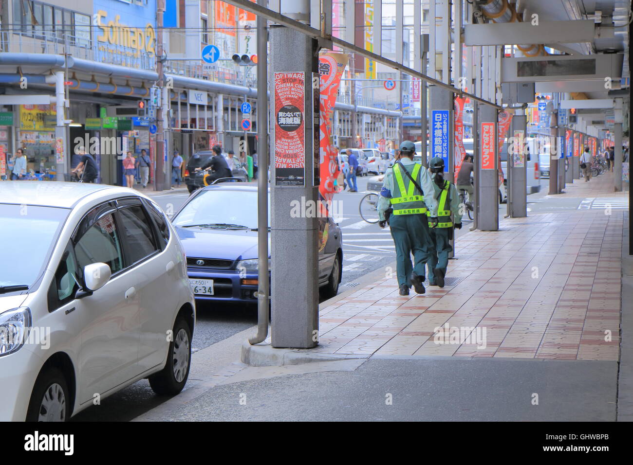 Parking ticket inspectors check parking tickets in Denden Town Osaka Japan Stock Photo Alamy