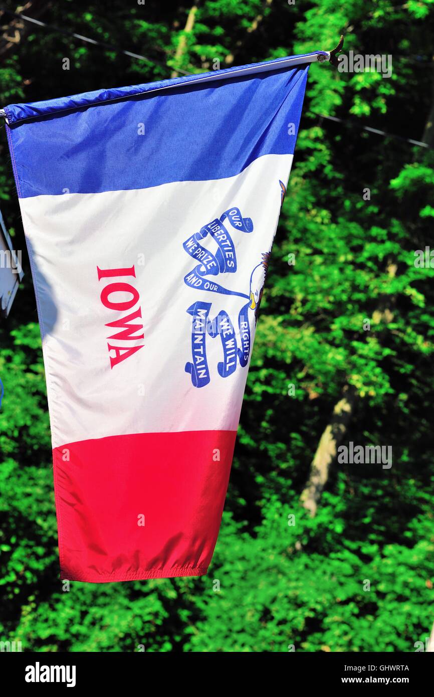 State flag of Iowa hanging from a shop front in Dubuque, Iowa, USA. Stock Photo