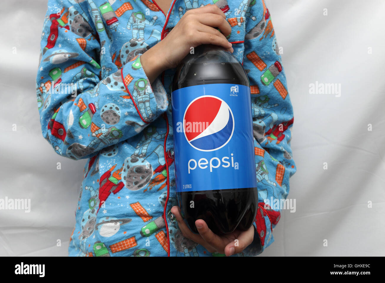 Child holding Pepsi soft drink Stock Photo