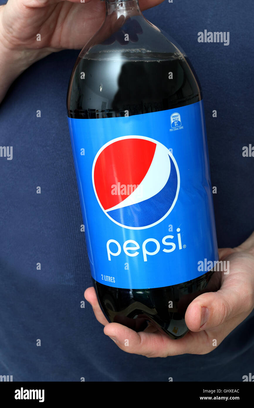 Adult male holding Pepsi soft drink Stock Photo