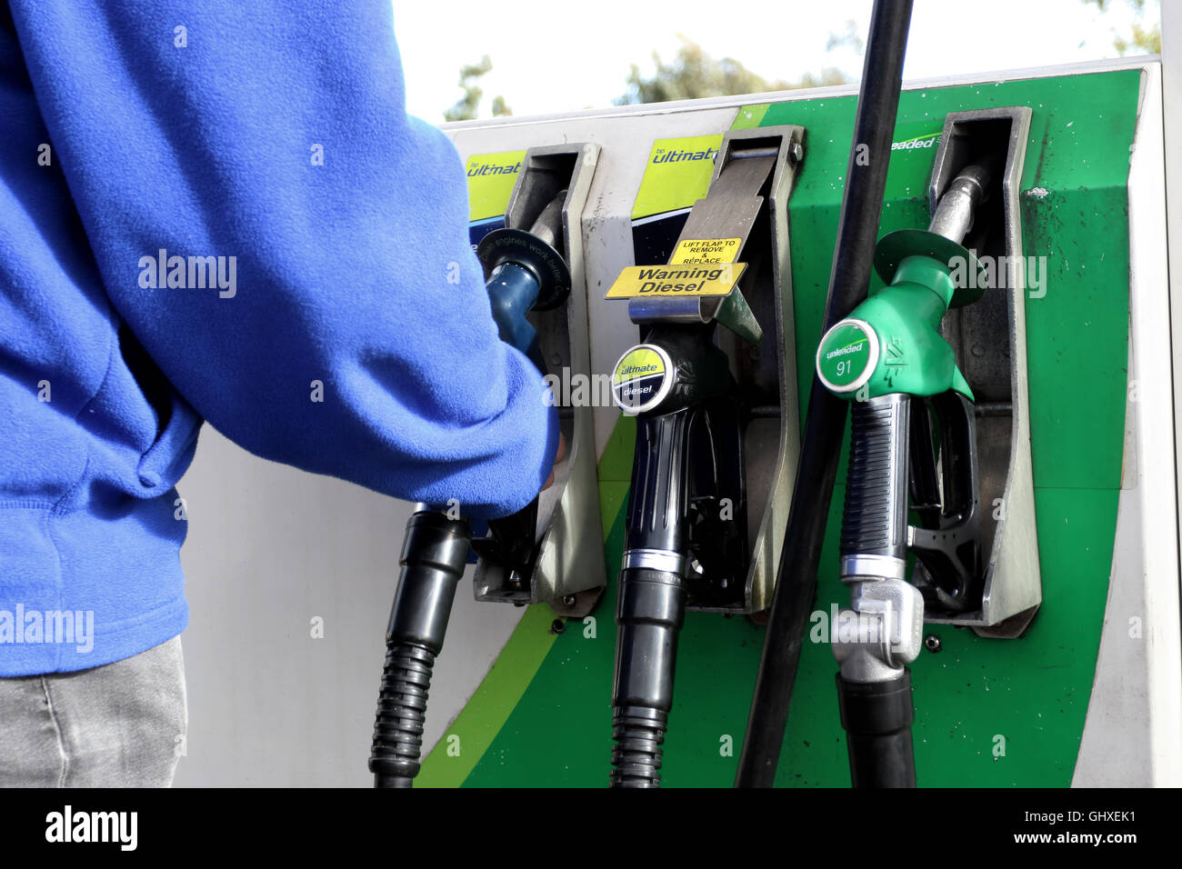 Adult male filling up petrol at BP  - British Petroleum petrol pump in Melbourne Victoria Australia Stock Photo