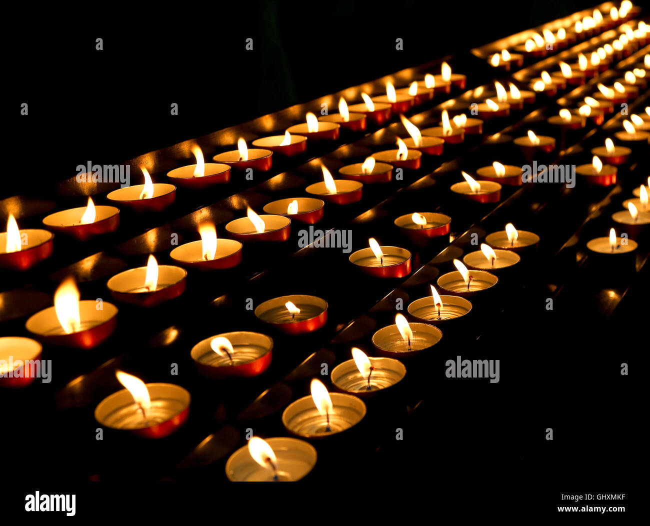 many candles lit inside the place of worship Stock Photo Alamy