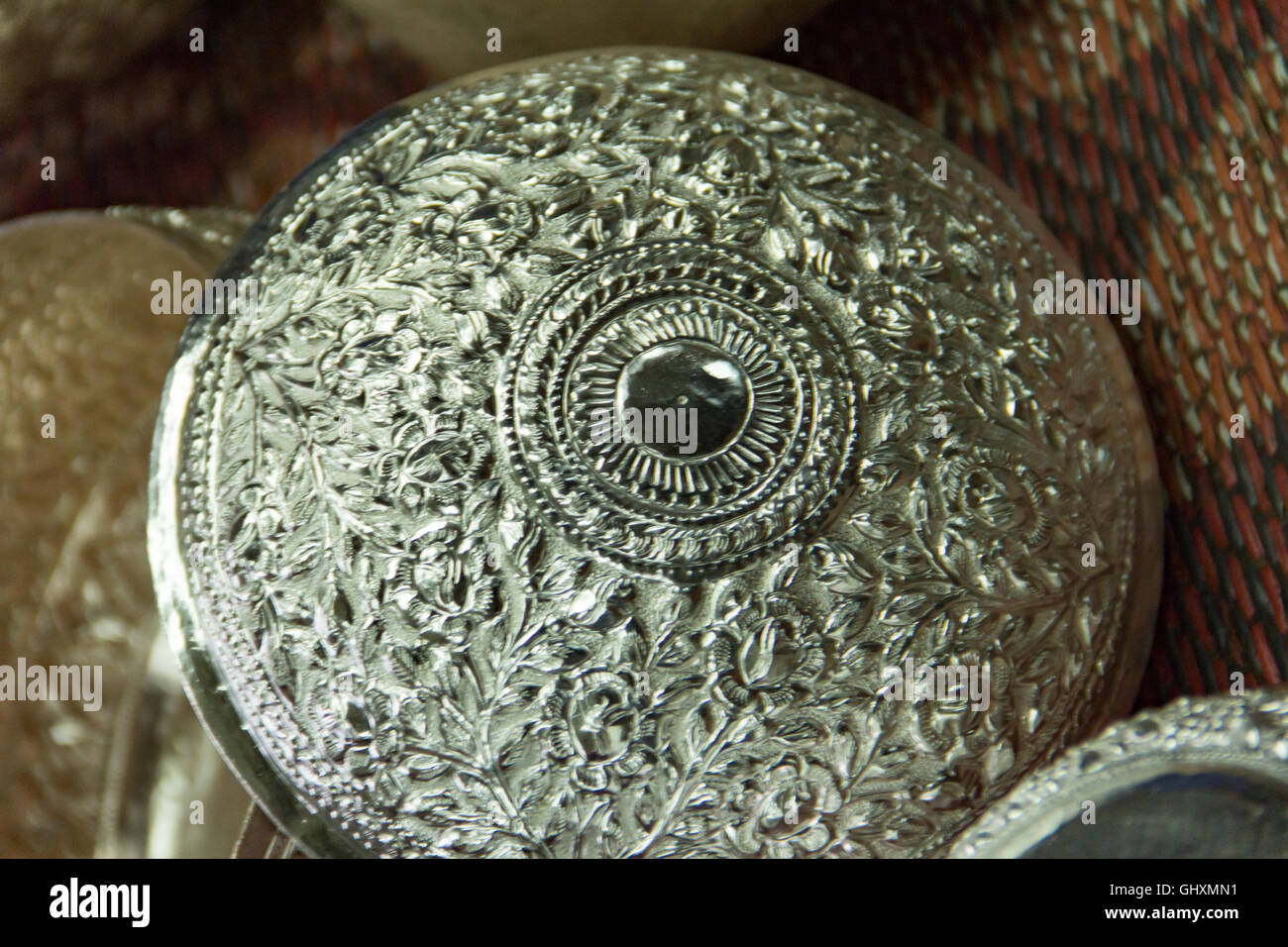 Intricate and delicate carving on hand crafted silver dish at Thailand artisan studio. Stock Photo